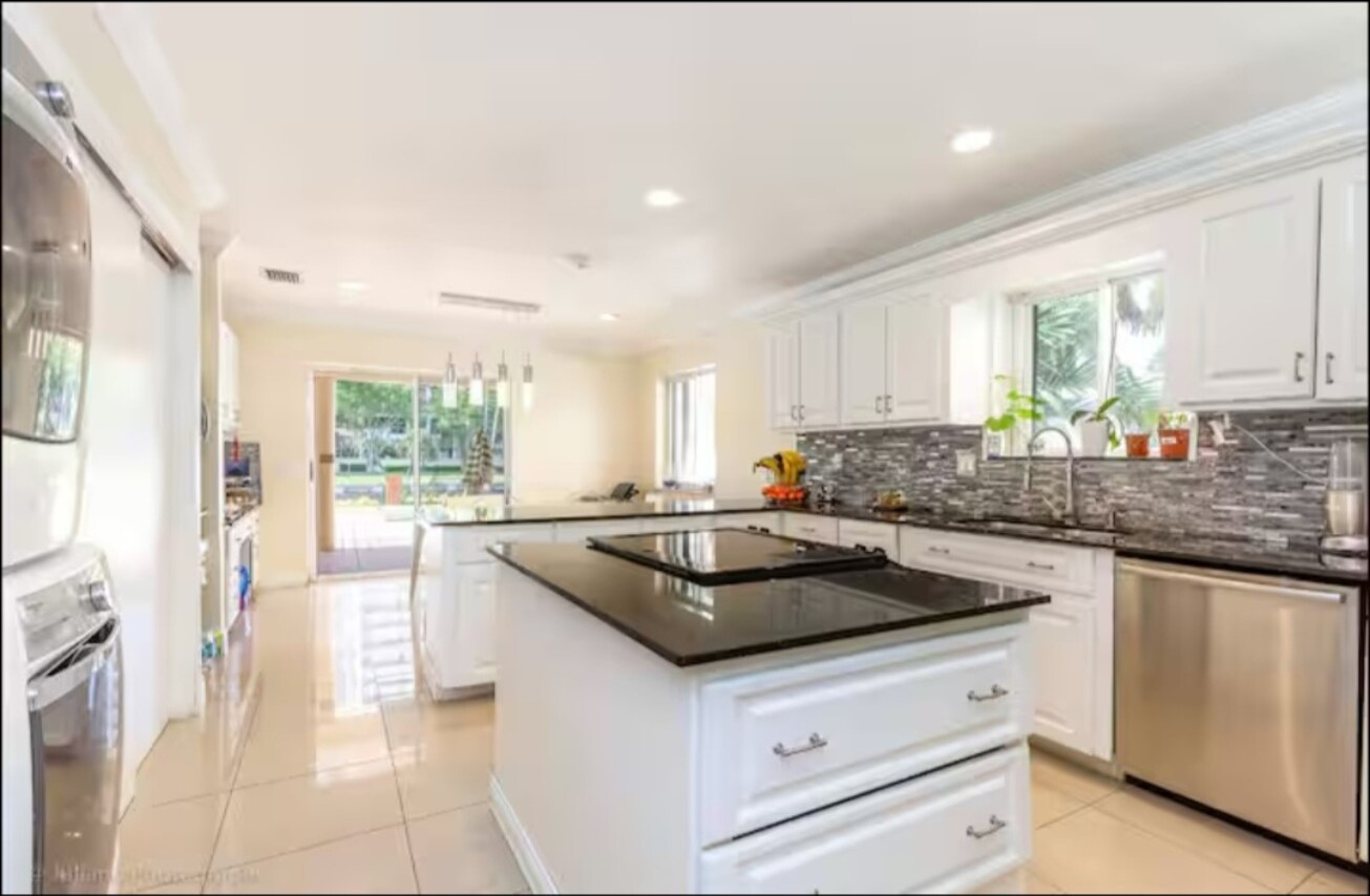 Bright white kitchen with polished counters after detailed professional cleaning