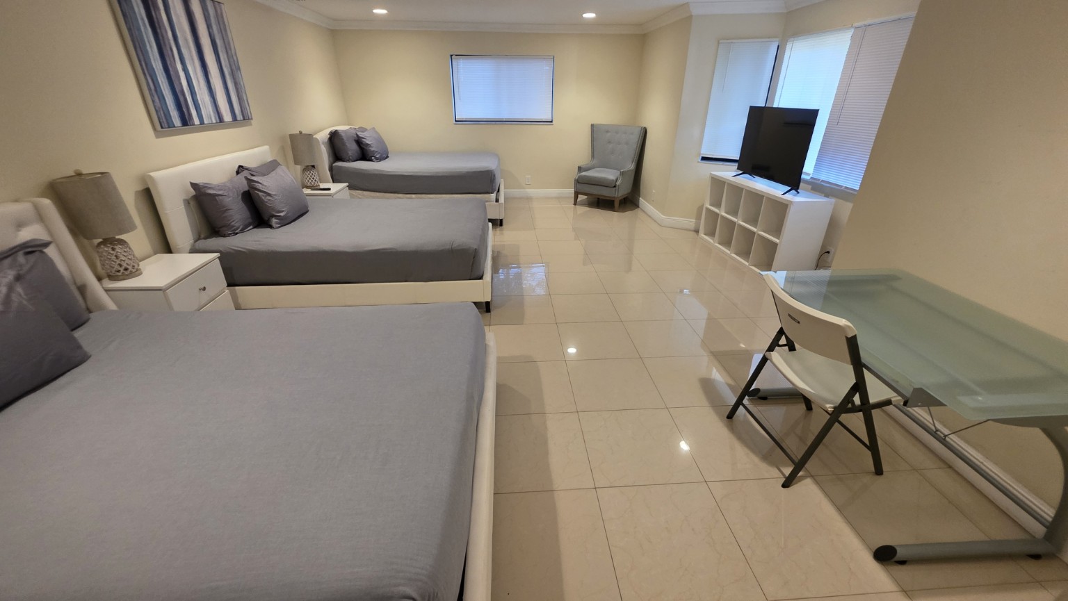 Bright multi-bed guest room fully organized and ready for arrival